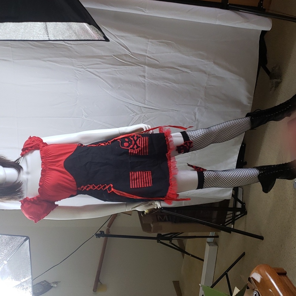 A women's priate outfit with fishneck stocking, boots, sword for holloween